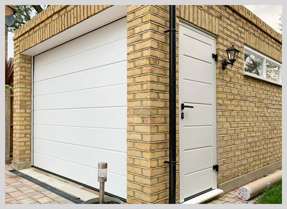 White garage door and pedestrian door set against a brick wall in London.