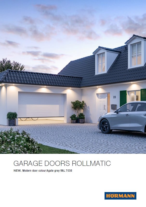 White Rollmatic garage doors installed on a residential home, showcasing a clean and modern design.