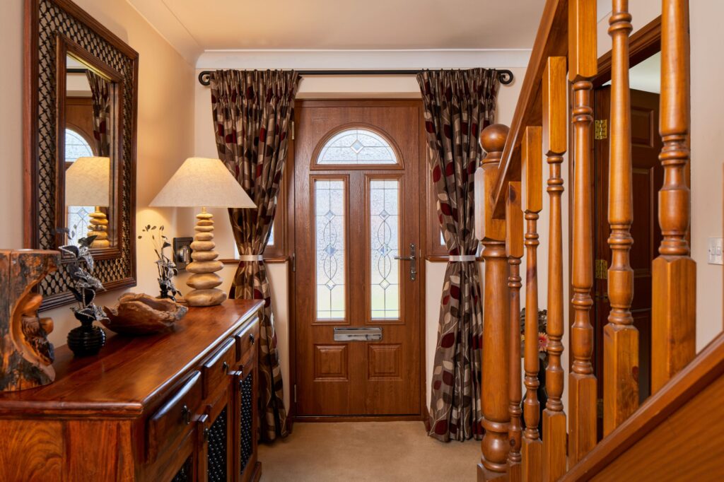 Hallway leading to a wood-style composite front door.